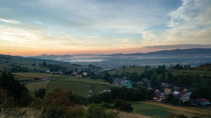 Sunrise Over Czorsztyn Lake with Mist and Rural Countryside in Pieniny Mountains