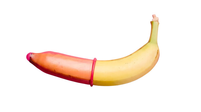 Yellow banana with a pink condom partially rolled over the tip for sexual health education isolated on transparent background