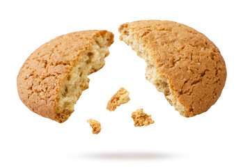 Oatmeal cookies broken in half fly close-up on a white. Isolated