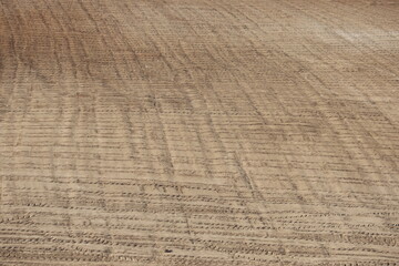 Detailed View of Arable Brown Soil with Parallel Plowing Patterns: Agricultural Land in Ceyhan Prepared for Planting with Distinctive Texture and Earthy Tones
