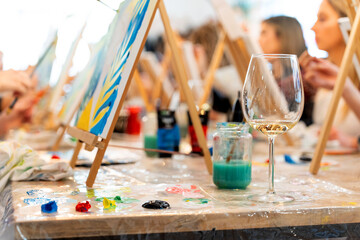 Women enjoying a sip and paint art event