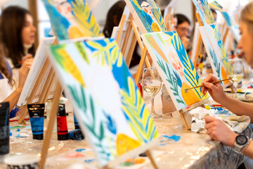 Women enjoying sip and paint art workshop