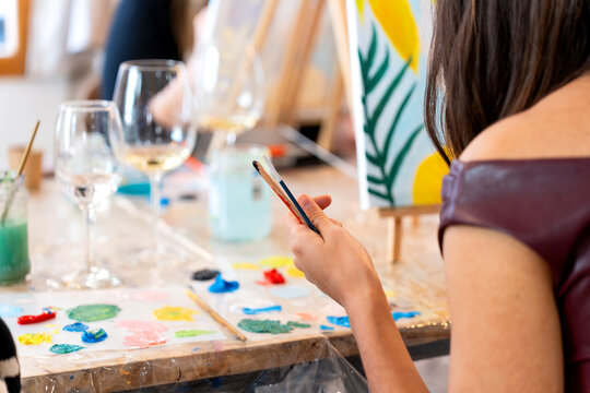 Woman enjoying sip and paint event creating art
