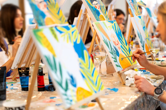 Women enjoying sip and paint art workshop