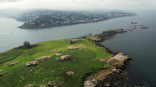 Aerial view of Dalkey Island's lush green landscape contrasting with the surrounding dark blue waters, Dalkey Island, County Dublin, Ireland.