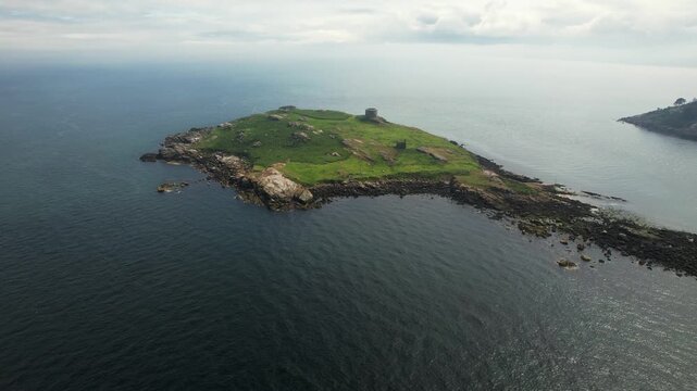Aerial view of the serene Dalkey Island, showcasing the ruins against the blue sea, a rugged coastline, and green vegetation, Dalkey Island, County Dublin, Ireland.