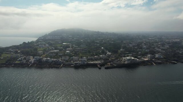 Aerial view of the Dalkey coastline, where the dark blue sea meets the land with buildings, Dalkey, County Dublin, Ireland.