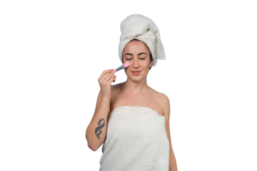 Young woman applying makeup blush to her cheek