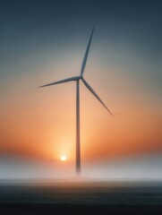Fototapeta premium A wind turbine rises above the ground with a backdrop of a setting sun and fog. The scene captures a moment in nature where technology meets the environment at dawn
