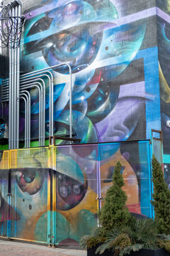 colorful mural at an old brick wall