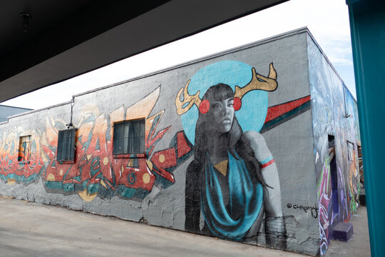 colorful mural at an old brick wall