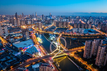Fototapeta premium Aerial night view of the Tianjin Eye Ferris wheel over the Haihe River in Tianjin, China