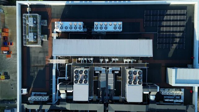 Aerial view of rooftop HVAC systems and solar panels creating a pattern of industrial and sustainable energy elements, Milton Keynes, England, United Kingdom.