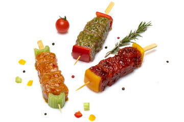 Three Raw Marinated Meat Kebabs With Vegetables And Rosemary On White Background