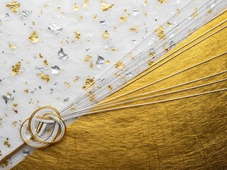 Close up of white and gold textured wallpaper with floral pattern