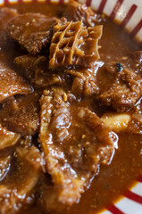 Close-up of tripe stew in a bowl being served