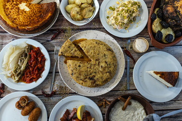 Spanish tapas and assorted dishes on wooden table
