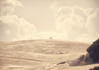 Stunning sunset over Cadiz beach, with golden hues reflecting on the Atlantic, framed by serene...