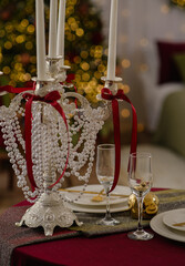 Decorated table with candles and pearls in a decorated room