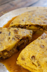 Spanish omelette slices on a plate with sauce