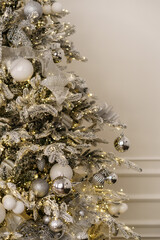 Light decorated Christmas tree on a light background