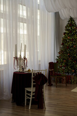 Decorated table with candles and pearls in a decorated room