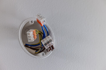 electric wires in the recessed wall junction box connected with splicing connectors. electrical installation