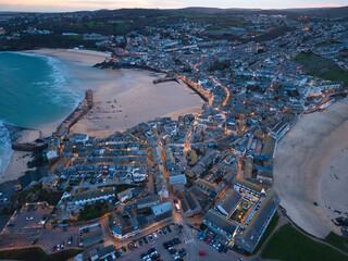 Vibrant twilight elevated capture of St Ives town, bay and beaches in Cornwall, UK