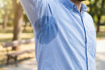 Professional Individual Experiencing Sudden Sweat Stain During Outdoor Midday Break
