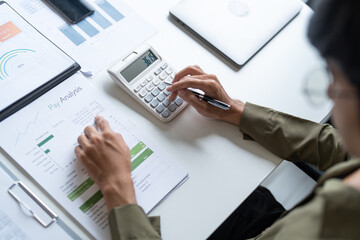 Male Professional Using Calculator for Business Budget Analysis.
