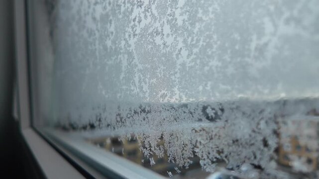 Winter window view, snowflakes and ice on glass