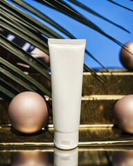 White cosmetic tube with cream featuring tropical leaves and gold accents on the background