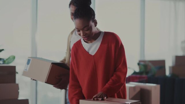 Woman packing parcels, Woman carefully sealing parcels with steady hands in cozy home studio environment