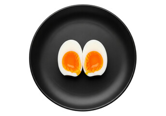 Soft Boiled Egg Halves on a Black Plate Overhead Shot