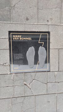 Wall plaque in Eindhoven featuring the footprints and signature of Dutch football legend Mark van Bommel. This tribute at the Philips Stadion honors his successful career with PSV Eindhoven.