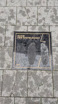 Commemorative plaque of famous Dutch footballer Ruud van Nistelrooy featuring his footprints, located on a stone-paved walk of fame in Eindhoven, Netherlands.