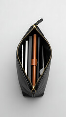 Black leather pouch filled with various stationery items on a white background, viewed from above.