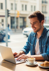 young man working on laptop in cafe