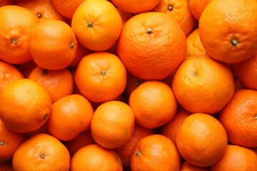 Many fresh ripe tangerines as background, top view