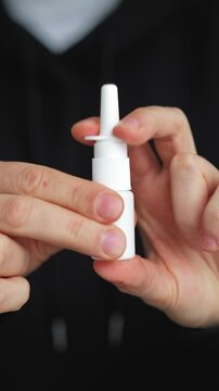 Nova cold spray.
Interdecine medication in a bottle on a black background.
A man holding a bottle of nasal spray.
Difficulty breathing.
Allergy sufferer during allergy season.