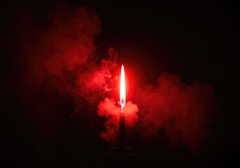 Fototapeta premium A bright red flare firework burning intensely against a dark background, creating thick, dramatic smoke ,vibrant ,light ,signal
