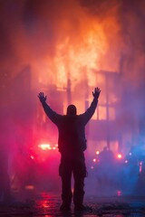 silhouette of a person with hands raised against fiery backdrop