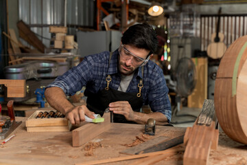 Carpenter Sanding Wood in Workshop, Skilled Craftsman Making Furniture with Hand Tools