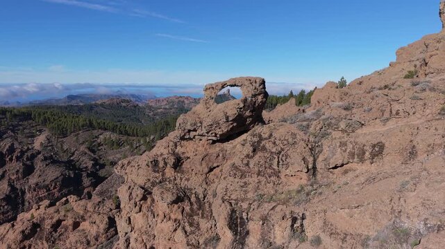 Beautiful aerial shot flying over the Nublo window revealing the Roque Nublo. Gran Canaria.