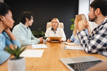 Diverse business team collaborating during important office meeting working together at workplace