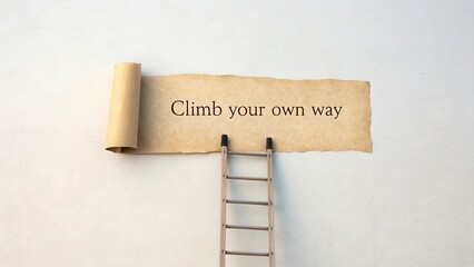 Ladder leaning toward a scroll with quote Climb your own way