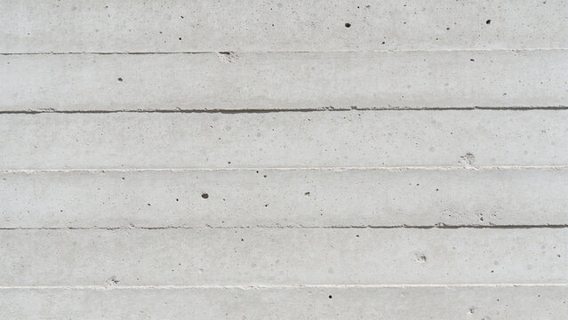Horizontal concrete wall with textured surface and linear grooves