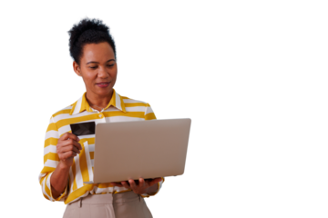 African american woman holding credit card and laptop, engaging in secure online shopping and e-commerce transactions