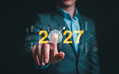 Businessman Pointing at 2027 Target on Virtual Screen for Future Goals