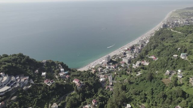 Aerial view of the Kvariati coastline in Adjara, Georgia, featuring seaside resorts, green hills, and the calm Black Sea. Peaceful coastal landscape with hotels, shoreline, and mountain backdrop